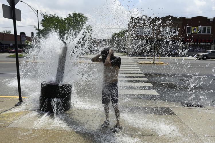 A person cools off with water from an open fire hydrant during a heat wave on the West Side of Chicago, Illinois, on July 2, 2026. Blistering temperatures and humidity gripped swaths of the United States on July 1, with the worst yet to come for the den...
