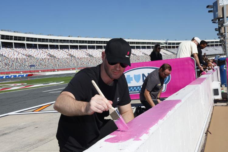 NASCAR drivers Cody Ware and Cole Custer helped paint pit wall pink as part of the 14th annual event at Charlotte Motor Speedway on Tuesday