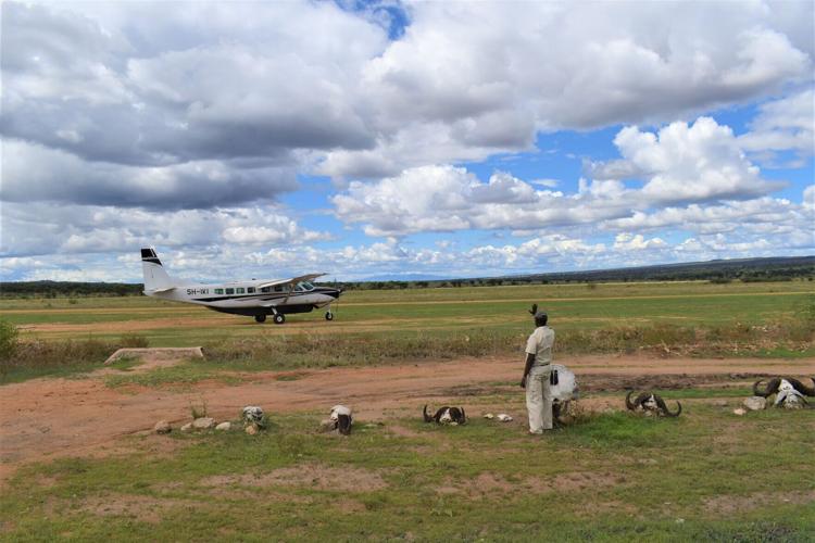 A bush plane touches down on a remote airstrip, bringing guests to the heart of Tanzania’ s wilderness on SkySafari.