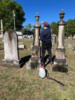 Members clean tombstones at Magnolia Cemetery