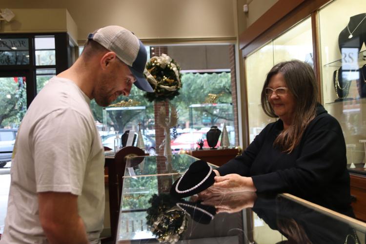 'See it, touch it, hold it' Despite inflation, shoppers flock to