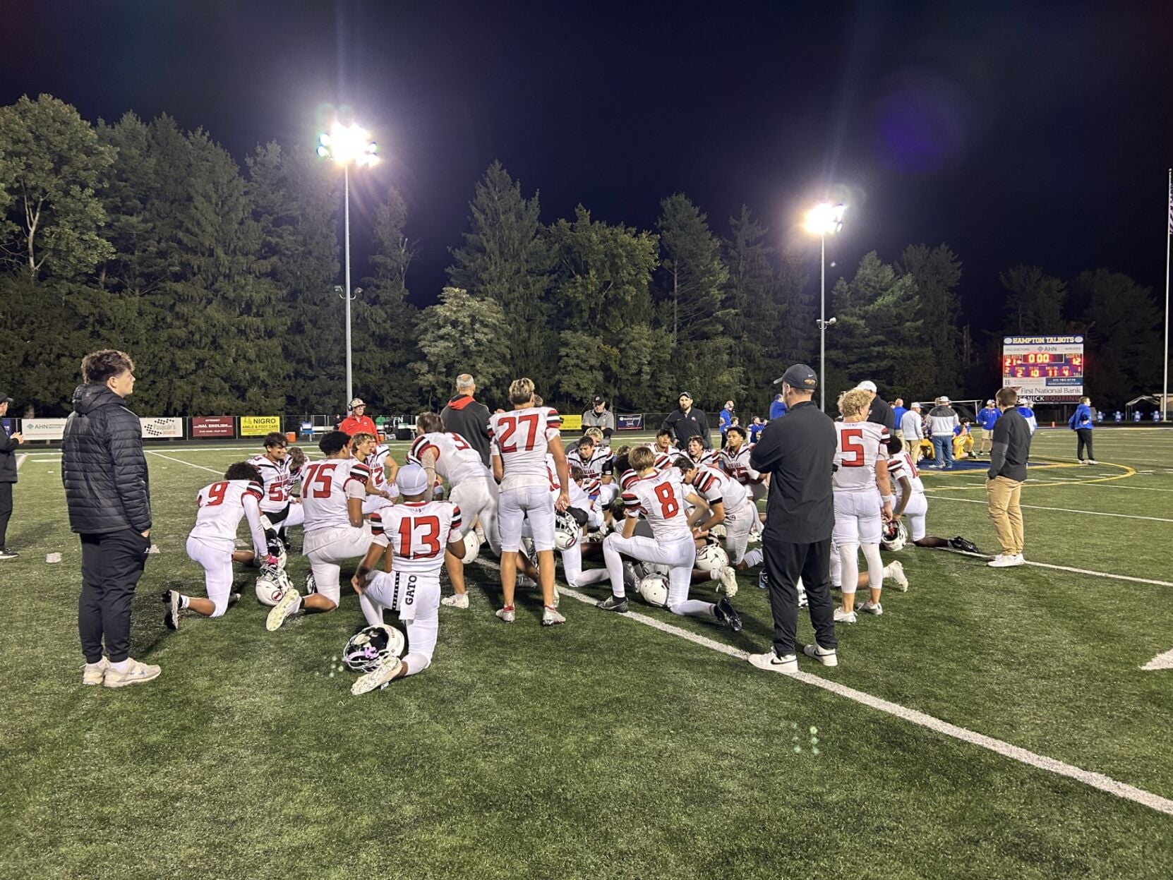 Indiana football players huddled during a high-stakes game against Hampton