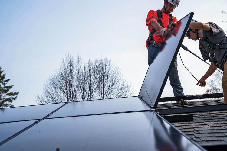 Workers installing solar on a roof