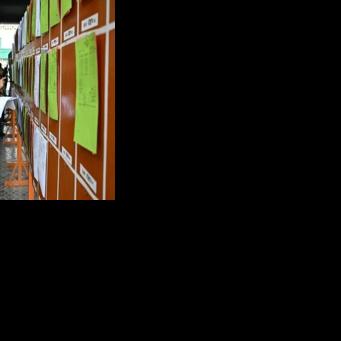 Members of the media look at documents of preliminary election results at the Election Commission office in Dhaka on February 13, 2026