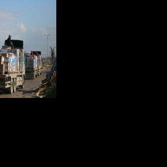 Trucks carrying WHO aid preparing to cross a checkpoint in the central Gaza Strip