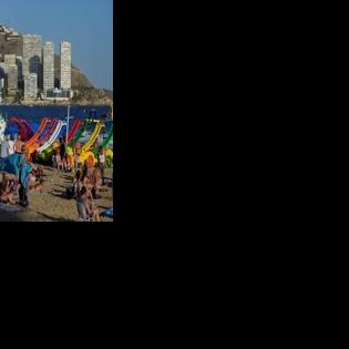 Bathers enjoy the Levante Beach in the popular Spanish resort of Benidorm on September 10, 2025