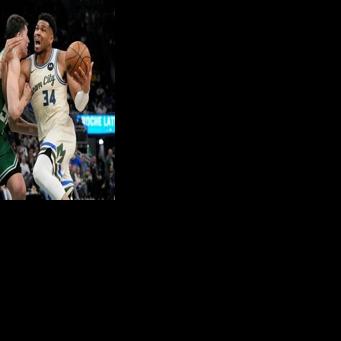 Giannis Antetokounmpo (right) returned from a five-week injury layoff but could not prevent the Milwaukee Bucks suffering a heavy defeat to the Boston Celtics