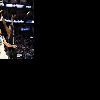 Golden State star Stephen Curry puts up a shot against Jae'Sean Tate in the Warriors' NBA loss to the Houston Rockets, Curry's first game since January 30