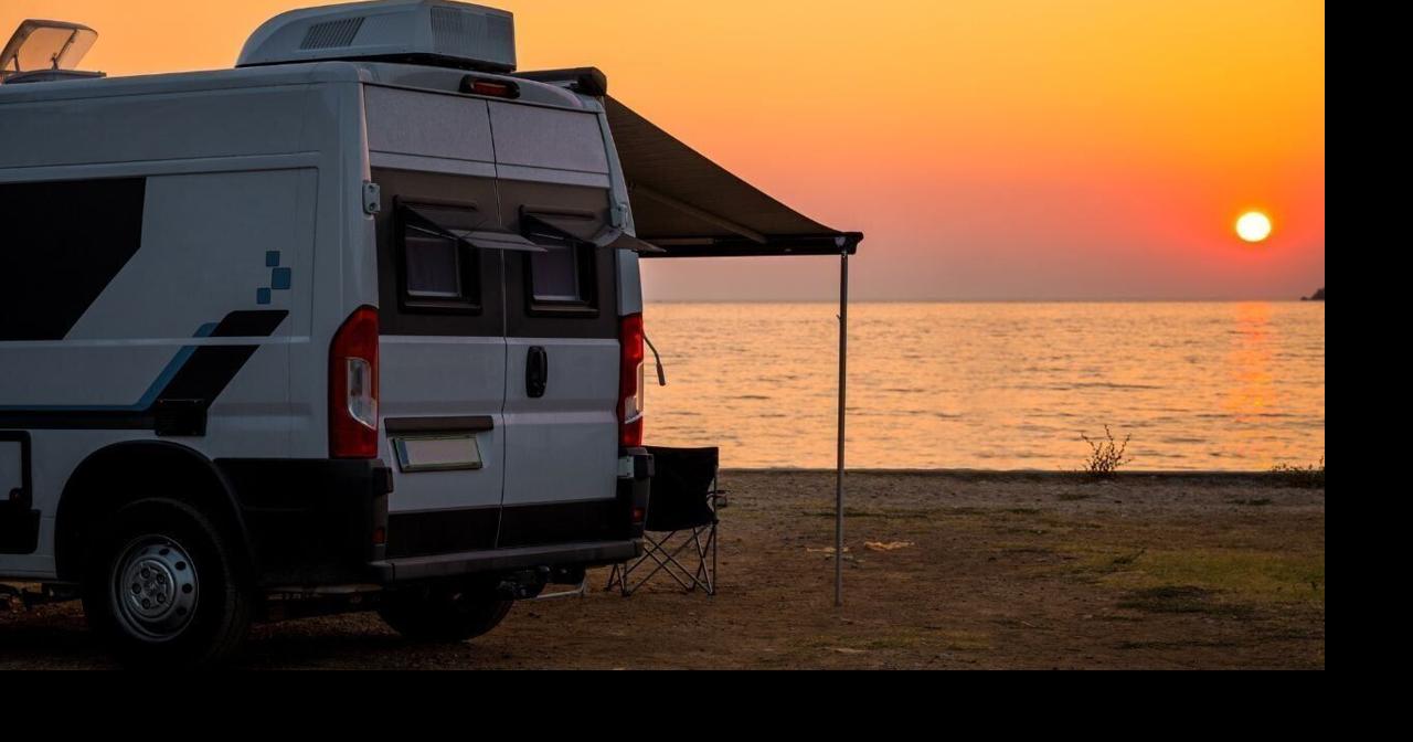 Campervan is parked on the beach at sunset. Campervan is parked on the beach next to the sea – wild camping in Croatia, Montenegro, Albania or Greece. Summer road trip