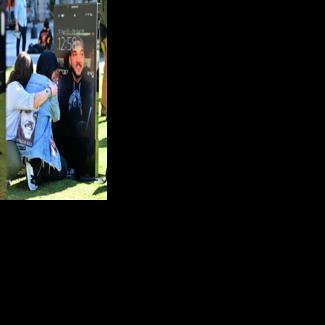 Bereaved parents and family members view images of deceased children displayed at the 'Lost Screen Memorial' in Los Angeles, an art installation featuring 50 children who lost their lives due to online harm