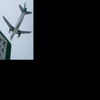 A plane flies in to land at Heathrow airport