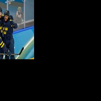 Sweden's Adrian Kempe (C) scored their first goal in a 5-1 win against Latvia to move into the Olympic men's ice hockey quarter-finals