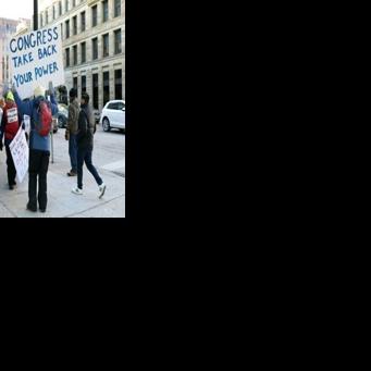 Demonstrators hold signs to protest the presence of federal agents in Minneapolis prior to the start of an NBA game between the Golden State Warriors and Minnesota Timberwolves at Target Center