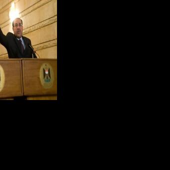 Then prime minister Nouri al-Maliki tries to block a shoe being thrown at then US president George W. Bush in 2009