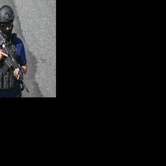 A police officer stands guard at the crime scene where a police officer was killed by alleged gang members in Guatemala City