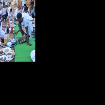 Sudanese people gather to break their fast on the first day of Ramadan