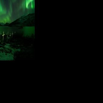 A cemetery in Kapisillit, Greenland, illuminated by the northern lights on February