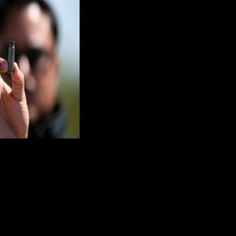 A man holds up a bullet casing found at the Mexican football field where at least 11 people were killed and scores wounded during an attack near the city of Salamanca
