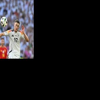 Spain's midfielder Mikel Merino fights for the ball with Germany's midfielder Florian Wirtz at Euro 2024