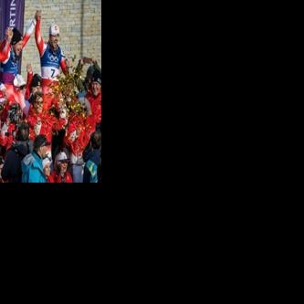Switzerland's gold medallists Franjo von Allmen and Tanguy Nef (L) celebrate with teammates Marco Odermatt and Loic Meillard (R) after the Olympic men's team combined
