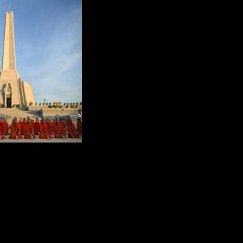 Cambodian Buddhist monks participate in a prayer for peace at the Win-Win monument