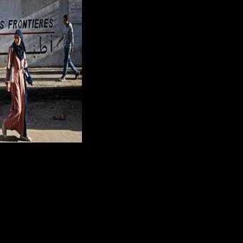 Palestinians walk past the MSF clinic in Gaza City's al-Rimal neighbourhood