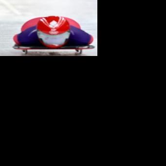 A drone follows Denmark's Nanna Johansen as she takes part in the skeleton women's training session at Cortina Sliding Centre