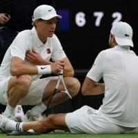 Jannik Sinner (left) consoles Grigor Dimitrov after the Bulgarian suffered an injury in their fourth-round match at Wimbledon