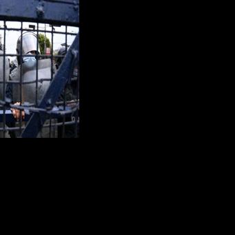 Police stand guard while Nepali former prime minister KP Sharma Oli's supporters protest against his arrest in Kathmandu on March 29, 2026.