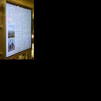 A man reads North Korea's Rodong Sinmun newspaper on a digital monitor at a metro station in Pyongyang