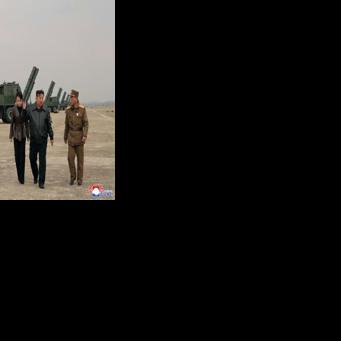 North Korean leader Kim Jong Un and his daughter Kim Ju Ae observing a training exercise