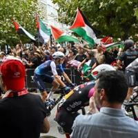 Israel Premier-Tech's Italian rider Marco Frigo passes pro-Palestinian demonstrators at the start of the 12th stage of the Vuelta a Espana, in Laredo