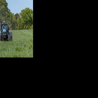 Fertilizer is spread across a field in North Carolina, where Andy Corriher farms