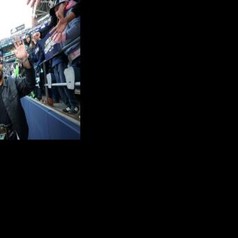 Seattle Seahawks defender Leonard Williams celebrates with fans during the NFL team's Super Bowl victory celebration and parade