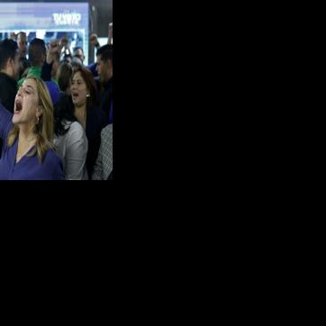 Supporters of Honduran presidential candidate Nasry Asfura celebrate after initial results are announced, putting him in the lead