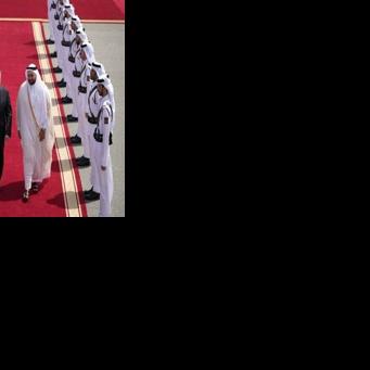 Qatari minister Mohammed al-Khulaifi bids farewell to Britain's Keir Starmer (L) at Doha airport