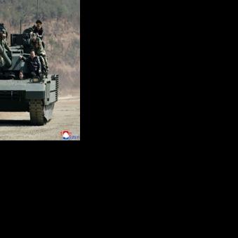 North Korean leader Kim Jong Un and his daughter Kim Ju Ae board a tank