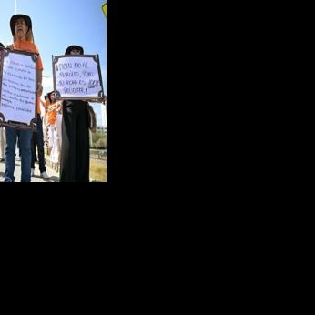 Demonstrators hold signs supporting the oil industry outside the international conference on transitioning away from fossil fuels, in Santa Marta, Colombia