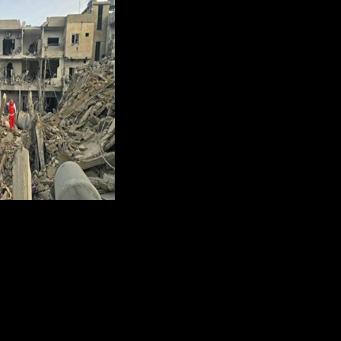 A rescue worker inspects the debris of destroyed buildings in the Maarakeh area near Lebanon's Tyre