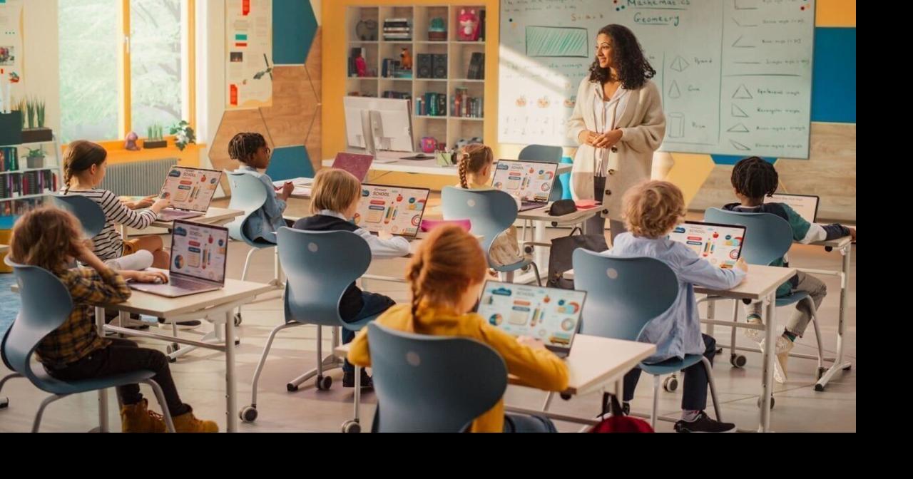 Elementary School Children Learning Basic Computer Knowledge: Teacher Educating Smart Diverse Kids in a Modern Colorful Classroom. Schoolchildren Getting Experience with Technology