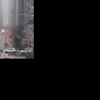 Pedestrians and cars move along 42nd Street in the Manhattan borough of New York City