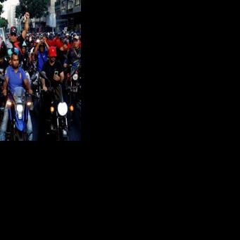 Government supporters ride motorcycles during a march one month after the ouster of Venezuelan President Nicolas Maduro demanding his release