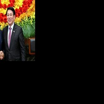 Vietnam's President Luong Cuong (R) shakes hands with European Council President Antonio Costa at the Presidential Palace in Hanoi