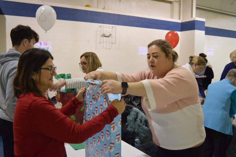 It's a wrap: Volunteers help Coalition for Kids wrap Christmas gifts