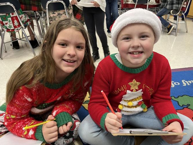 Students writing about their favorite thing about Christmas.JPG