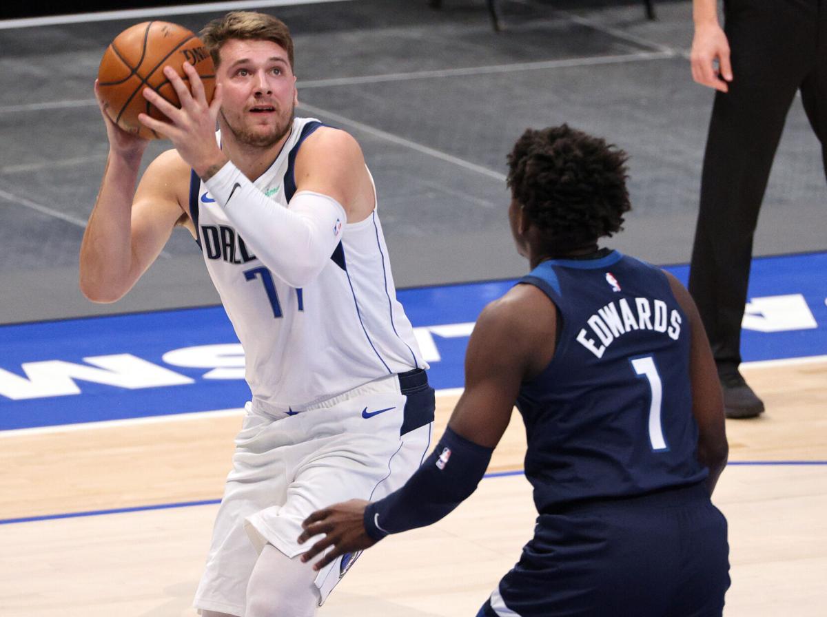 The Dallas Mavericks' Luka Doncic, left, takes a shot against the Minnesota Timberwolves' Anthony Edwards during a preseason game at American Airlines Center in Dallas on December 17, 2020.