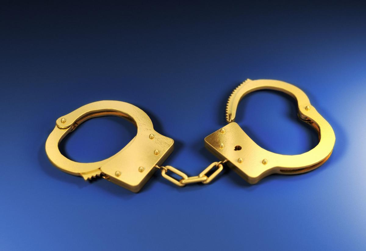 Gold handcuffs on blue background