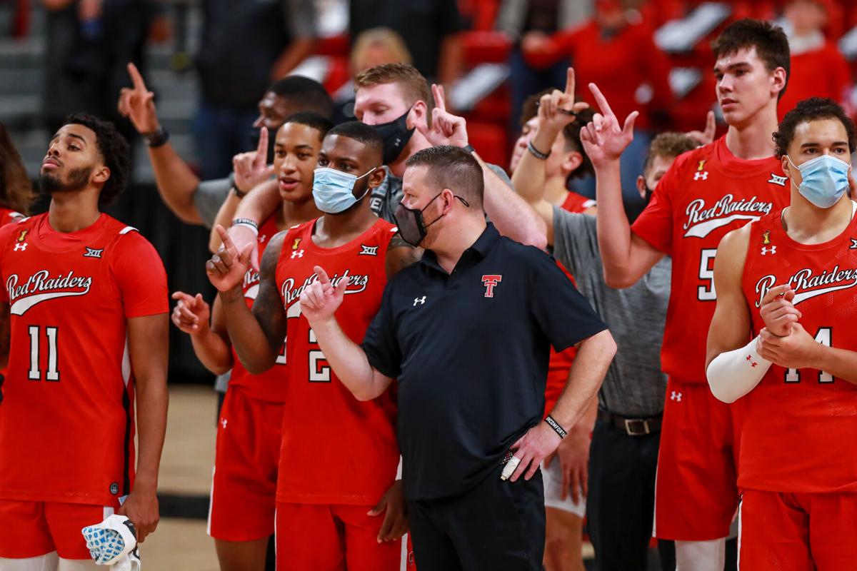 On December 6, 2020, Texas Tech guards Kyler Edwards and Jamarius Burton, head coach Chris Beard, center Vladislav Goldin and forward Marcus Santos-Silva and the rest of the Red Raiders stand for The Matador Song after a game against Grambling State at ...