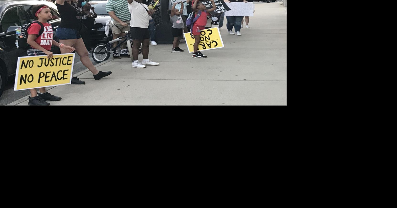 A group of 25 protesters marched around the Forsyth County Jail as they ...