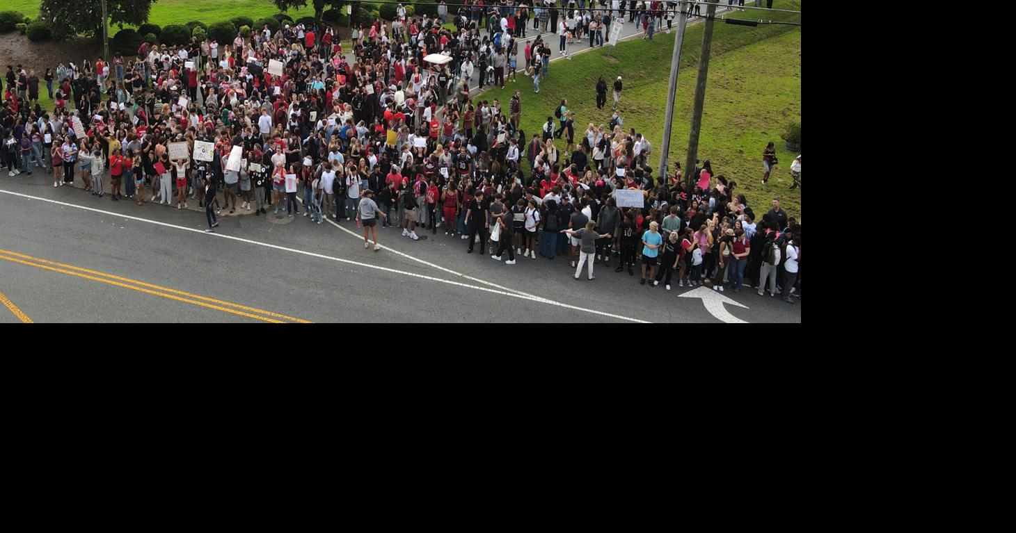 Forsyth County students stage walkout to protest job cuts